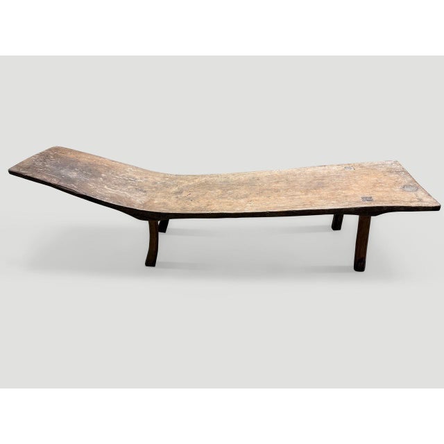 For the primitive collector. This rare bench or chaise is hand carved from a single teak slab from Madura. Circa 1890....
