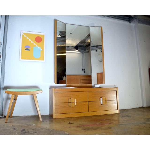 This is a beautifully designed mirrored chest of drawers from the 1970s. The veneer is oak. The chest features four...