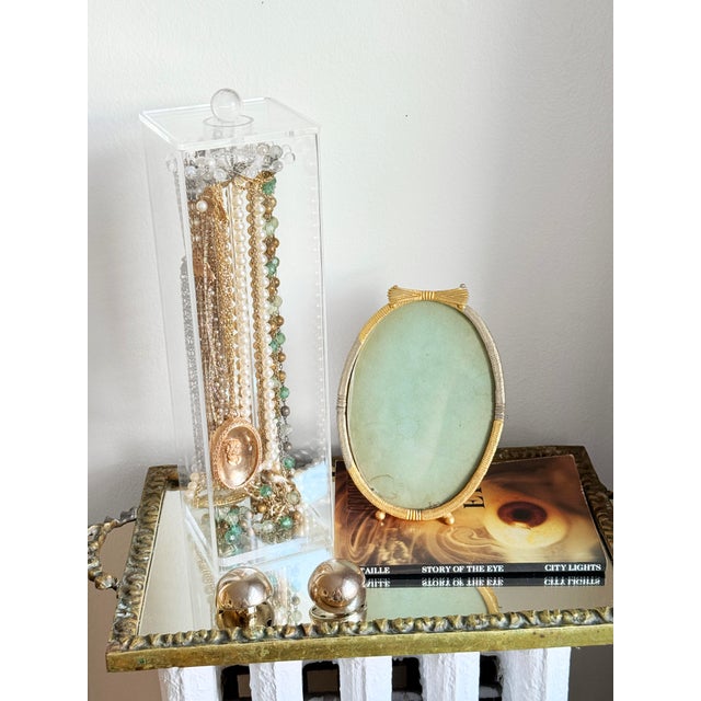 Postmodern clear acrylic jewelry caddy designed as a vertical necklace and accessory holder. The structure features a...