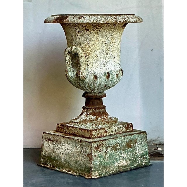 Elevate your indoor or outdoor living space with this magnificent Vintage Regency Distressed Wrought Iron Urn, a testament...