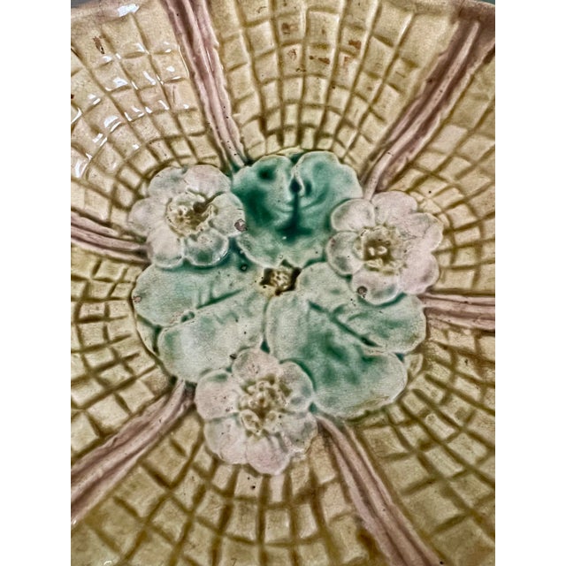 A charming vintage majolica bowl featuring a sculptural lily pad design and graceful footed base. The rich glaze showcases...