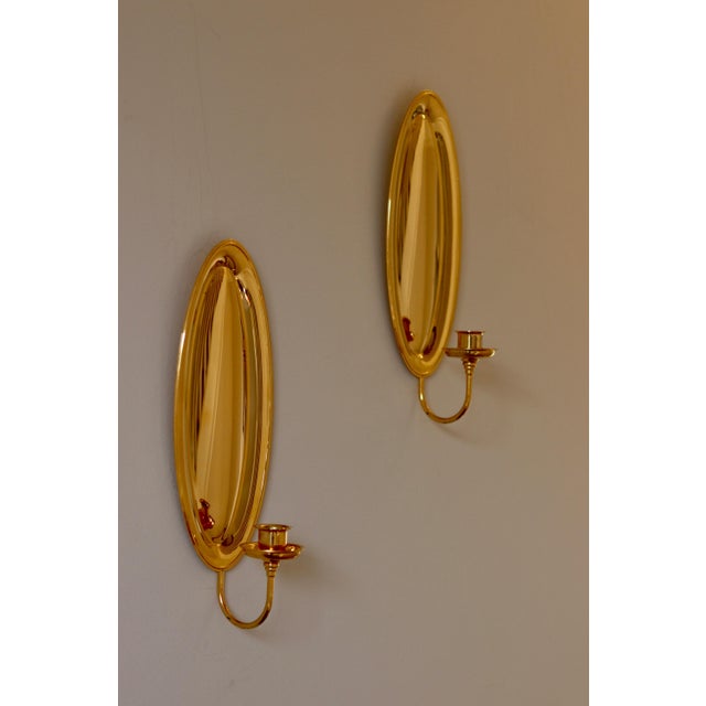 Made in Sweden. Mid-century wall sconces by Scandia Sweden, plated in 24K gold, exhibit exquisite craftsmanship....