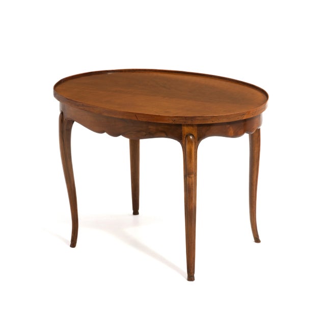 A simple and sophisticated antique French walnut coffee, cocktail or side table. Subtle cabriole legs with delicate hoof...