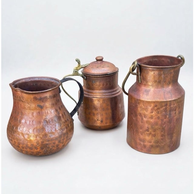 A beautifully coordinated collection of three vintage hammered copper vessels, each with its own distinctive form and...