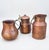 A beautifully coordinated collection of three vintage hammered copper vessels, each with its own distinctive form and...