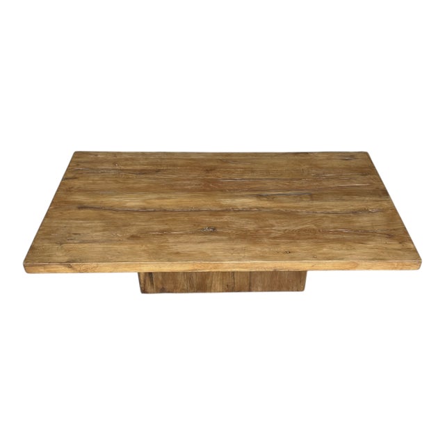 This striking solid teak coffee table showcases a bold architectural design with a substantial 2-inch-thick rectangular...