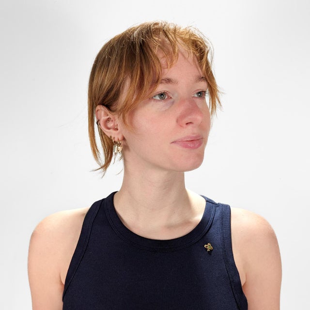 A fine antique stickpin. In 14 karat yellow gold. Bezel-set with a jade green colored glass cabochon to the center of an...