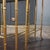 Set of three faux bamboo nesting tables with tinted mirror glass by the French firm Maison Baguès. Gold-tone finish with a...