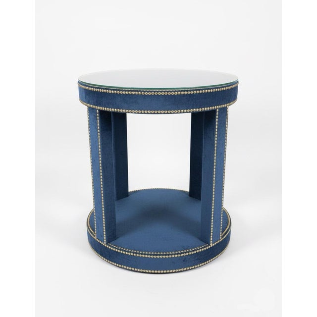 Add a touch of tactile luxury and sophisticated "mod" flair to your space with this upholstered round side table. Wrapped...