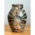 This vintage ceramic vase is a richly textured piece of studio pottery, with an ovoid, softly tapered body rising from a...