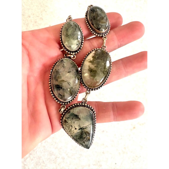 A wonderfully unique prehnite necklace set in sterling silver. Accented with black.