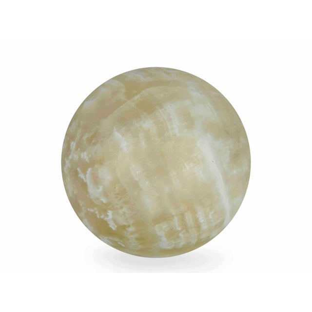 Elevate your tabletop or bookshelf with this striking hand-polished Honey Onyx sphere. Carved from natural banded calcite,...