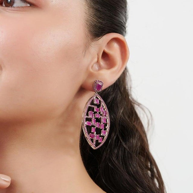 These captivating 14.05 carat natural ruby statement earrings are crafted in 925 sterling silver and feature a striking...