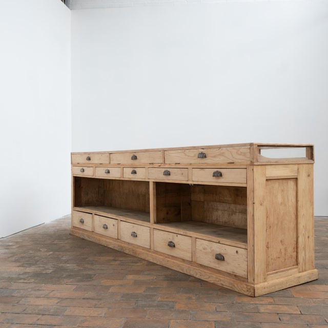 Large antique fir counter, fully glazed on its top and front. It features sliding glass doors, interior shelves, and...