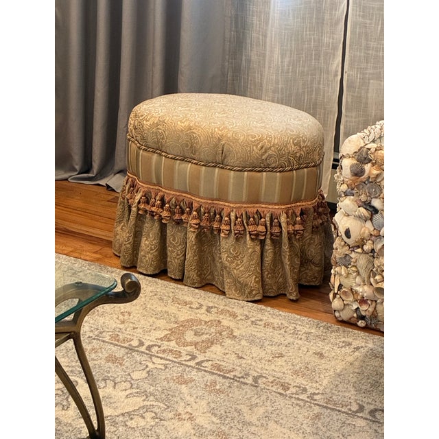 It features an oval silhouette wrapped in a muted Sage and Cream damask upholstery fabric with a coordinating vertical...