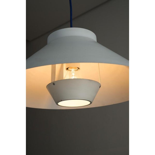 Pendant light from the 1970s, that embodies the functional elegance of Scandinavian Modern design. The fixture features a...