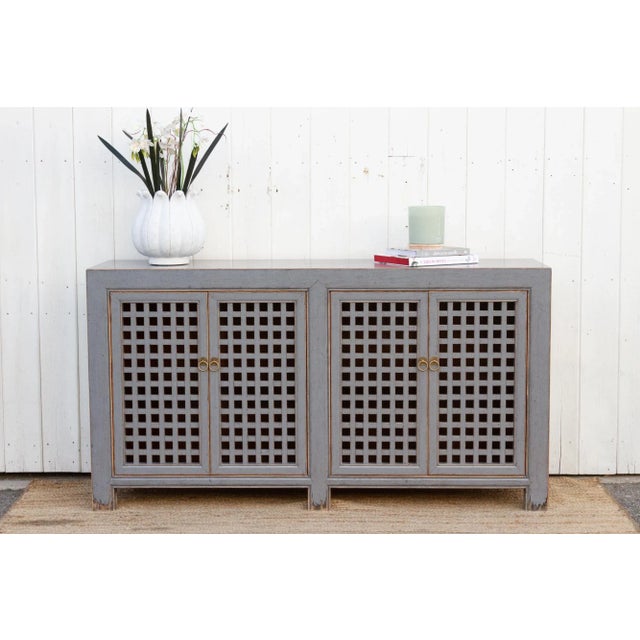 This modern Asian sideboard cabinet blends modern style with timeless elegance, making it a versatile statement piece for...