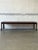 This striking rectangular coffee table features clean architectural lines and an expansive surface. The streamlined...