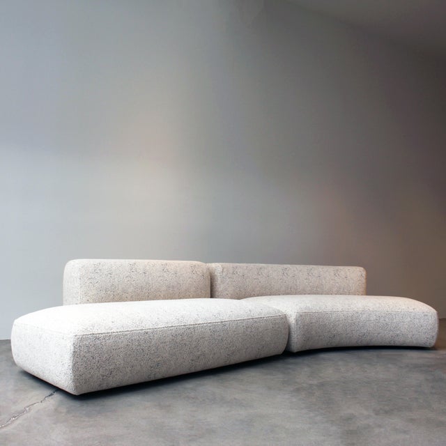 MDF Italia Cosy Curve Sofa with a cream fabric.