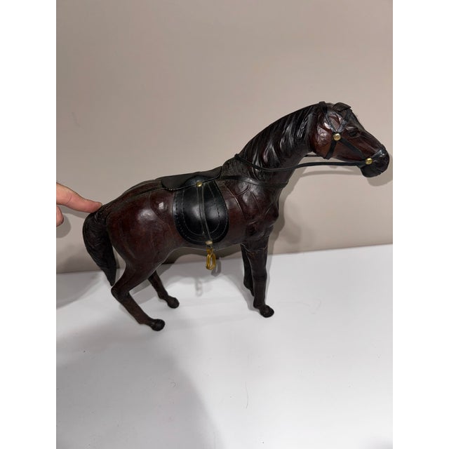 Pair of Vintage Leather Covered Horses, Circa 1930s–1940s A handsome pair of vintage leather-covered horses dating to...