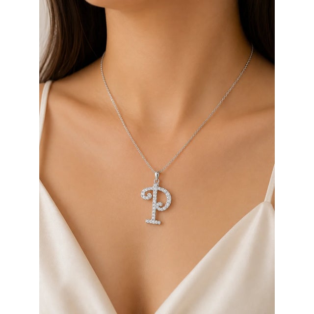 This modern 18K white gold pendant necklace features a "P" initial slide accented with brilliant diamonds totaling 0.4...
