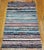 This striking vintage Moroccan Boucherouite rug from the third quarter of the 20th century is a work of exuberant abstract...