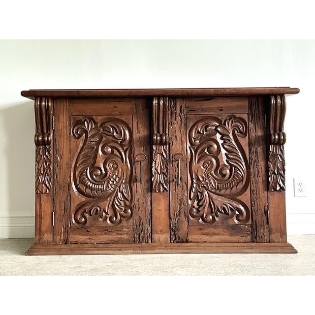 This monumental Spanish Revival sideboard is a masterwork of rustic elegance and architectural depth, making it a...
