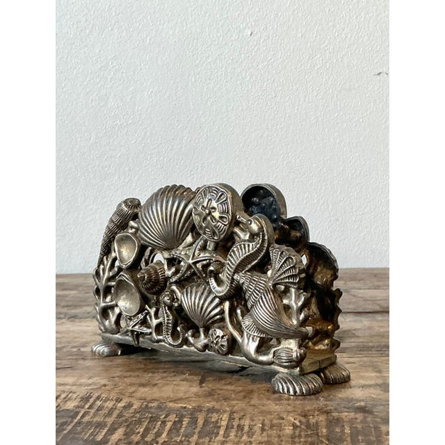 This vintage napkin holder is a charming tribute to the beauty of the sea, making it a perfect functional accent for any...