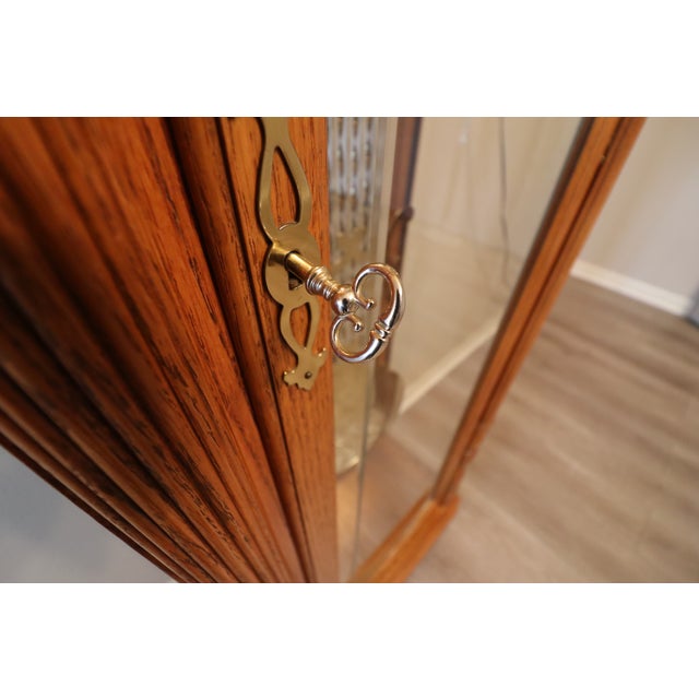 Crafted in warm golden oak with bookmatched burl panels and a classic arched bonnet, this Richmond model presents with...