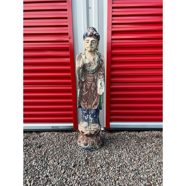 Likely Chinese, late 19th to early 20th century. This carved buddha figure traditional features including elongated ears,...