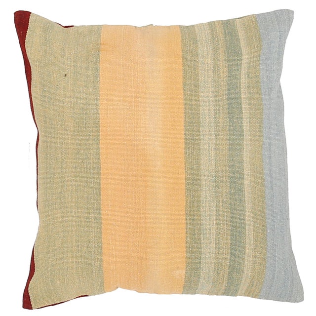 A one-of-a-kind handwoven wool kilim floor pillow featuring a fresh sage, gold, and sky-blue stripe. Fully reversible —...