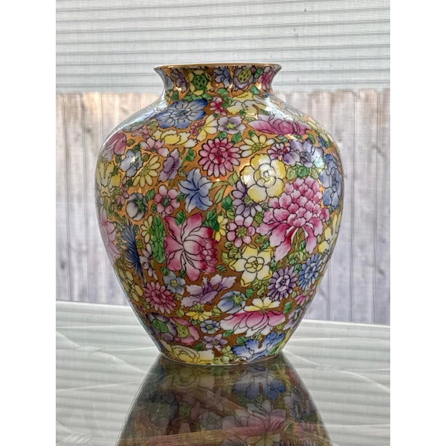 Vibrant hand painted Mille Fleur porcelain vase / urn made in Japan and hand painted in Hong Kong. The "Mille Fleur" or...