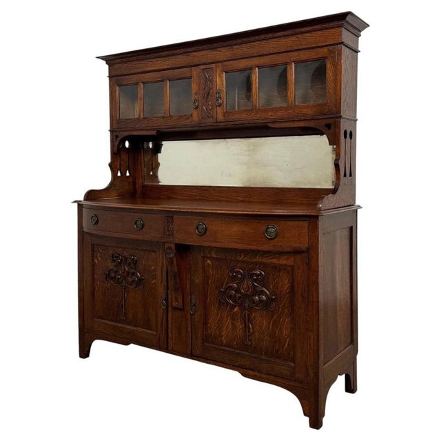 An impressive and exceptionally well-crafted early 20th-century English Arts and Crafts sideboard, constructed in richly...