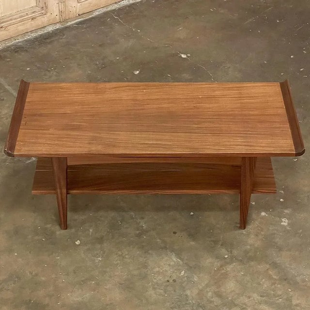 Mid-Century Modern Mahogany Coffee Table combines tailored lines with extraordinarily fine materials to create a timeless...