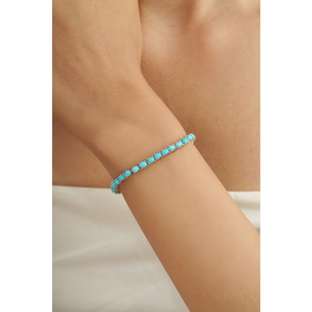 This Handcrafted Blue Turquoise Tennis Bracelet brings a vibrant pop of color to a timeless silhouette. Crafted in 925...