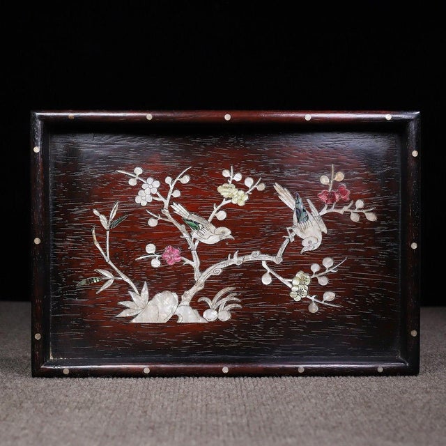 This is a beautifully crafted rectangular wooden tray featuring intricate mother-of-pearl (nacre) inlay work. Crafted from...