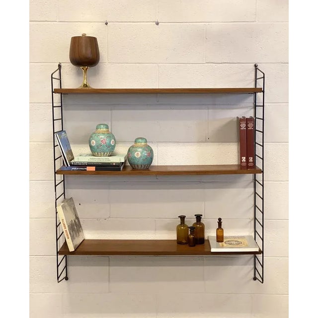 String hanging bookcase from the 60s by Nils “Nisse” Strinning for String Design AB, black lacquered metal structure, 3...