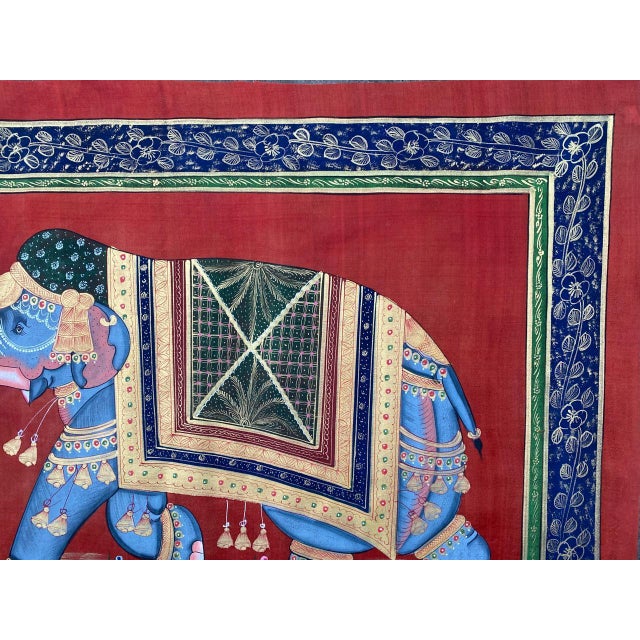 A royal elephant pigment painting on cloth from India's mughal period. This painting depicts a walking elephant on red...