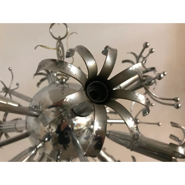 This mid-century chrome Sputnik chandelier measures 90 cm including the chain and ceiling canopy. It has 12 light and...