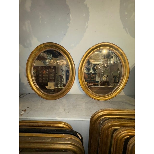 These French Louis Philippe giltwood oval mirrors are a luxurious addition to any home decor. The elegant design and gold...