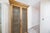 1960s Gold Leaf Finish Wood Cabinet With Carved Lattice Doors and Glass Shelving For Sale - Image 4 of 7