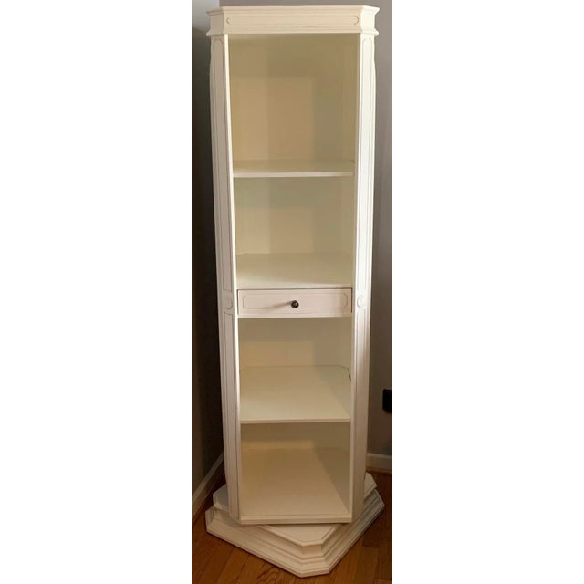 Tall bright white rotating mirrored jewelry accessory armoire features solid MDF engineered wood construction with modern...