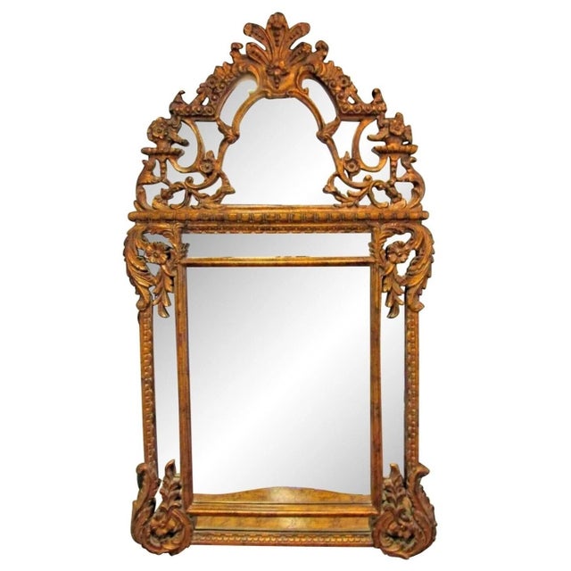 This Antique Carved Large French Rococo Gold Wood Wall Mirror is a stunning piece of furniture with a gold frame made of...