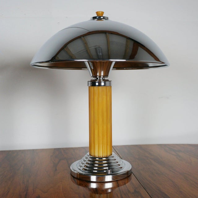 A pair of art deco dome lamps. Yellow rippled bakelite stem with chromed metal shade and a circular stepped chromed metal...