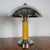 A pair of art deco dome lamps. Yellow rippled bakelite stem with chromed metal shade and a circular stepped chromed metal...