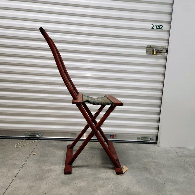 Folding chair from Yunan Province in China 19th century Carved back and original patina Seating material is from Qing...