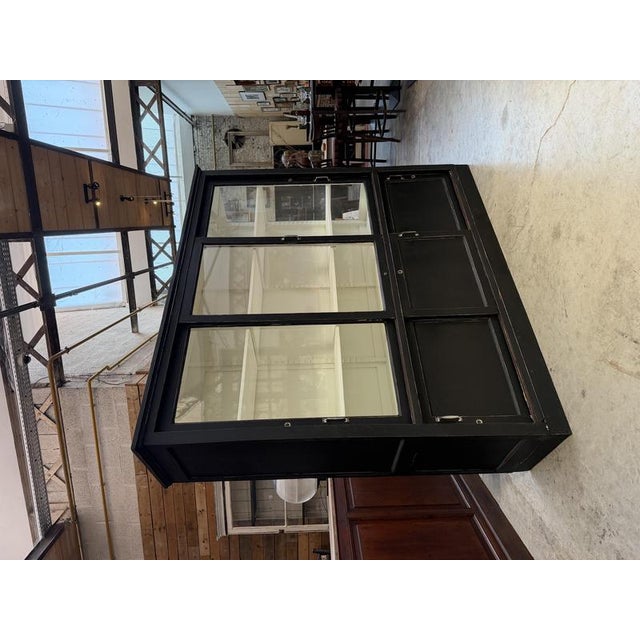 This 1950s display cabinet has been completely restored. It features three sliding glass doors in the upper section that...