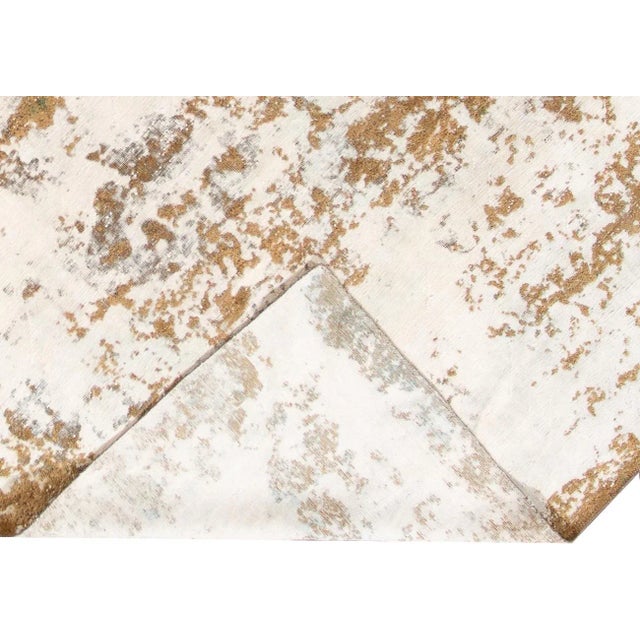 Beautiful hand-knotted vintage wool rug with a goldenrod field. This distressed rug has white accents featuring an...