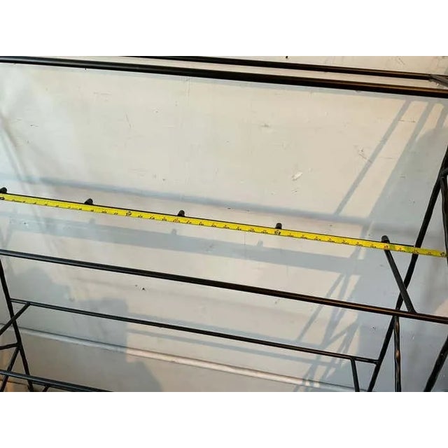 A pair of steel wall shelves. Interesting detail to the metal.No glass.