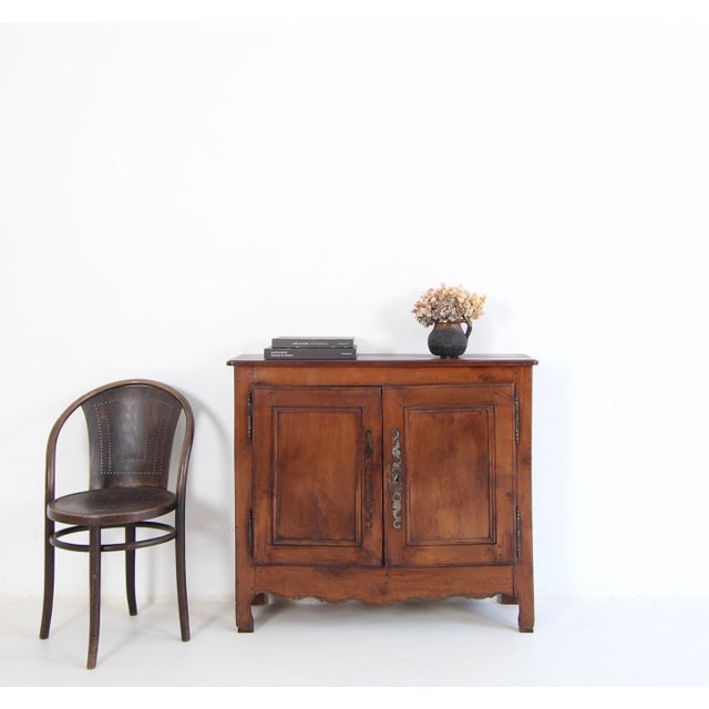 A small French provincial sideboard in cherry wood. Originally from the first half of the 19th century, this piece has...